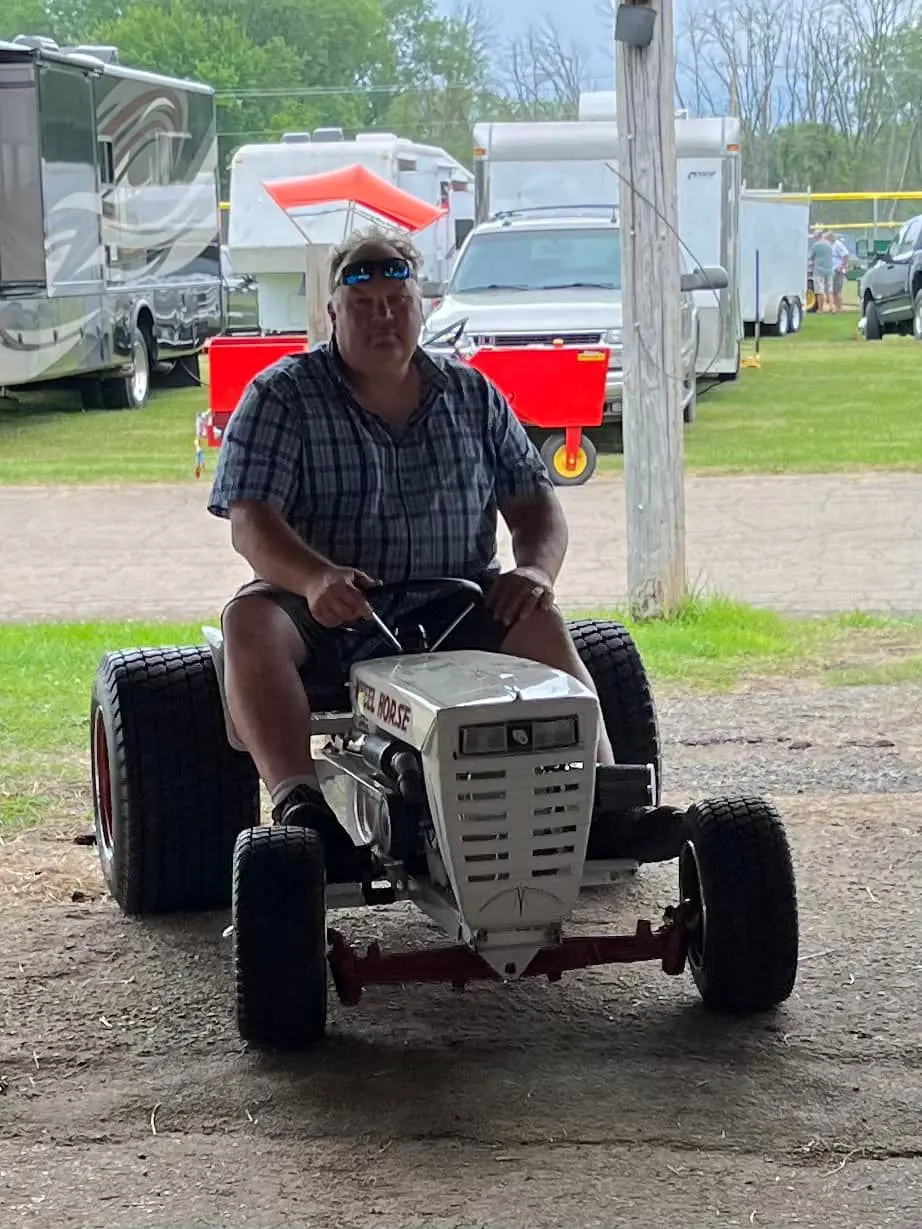 a man driving a small tractor