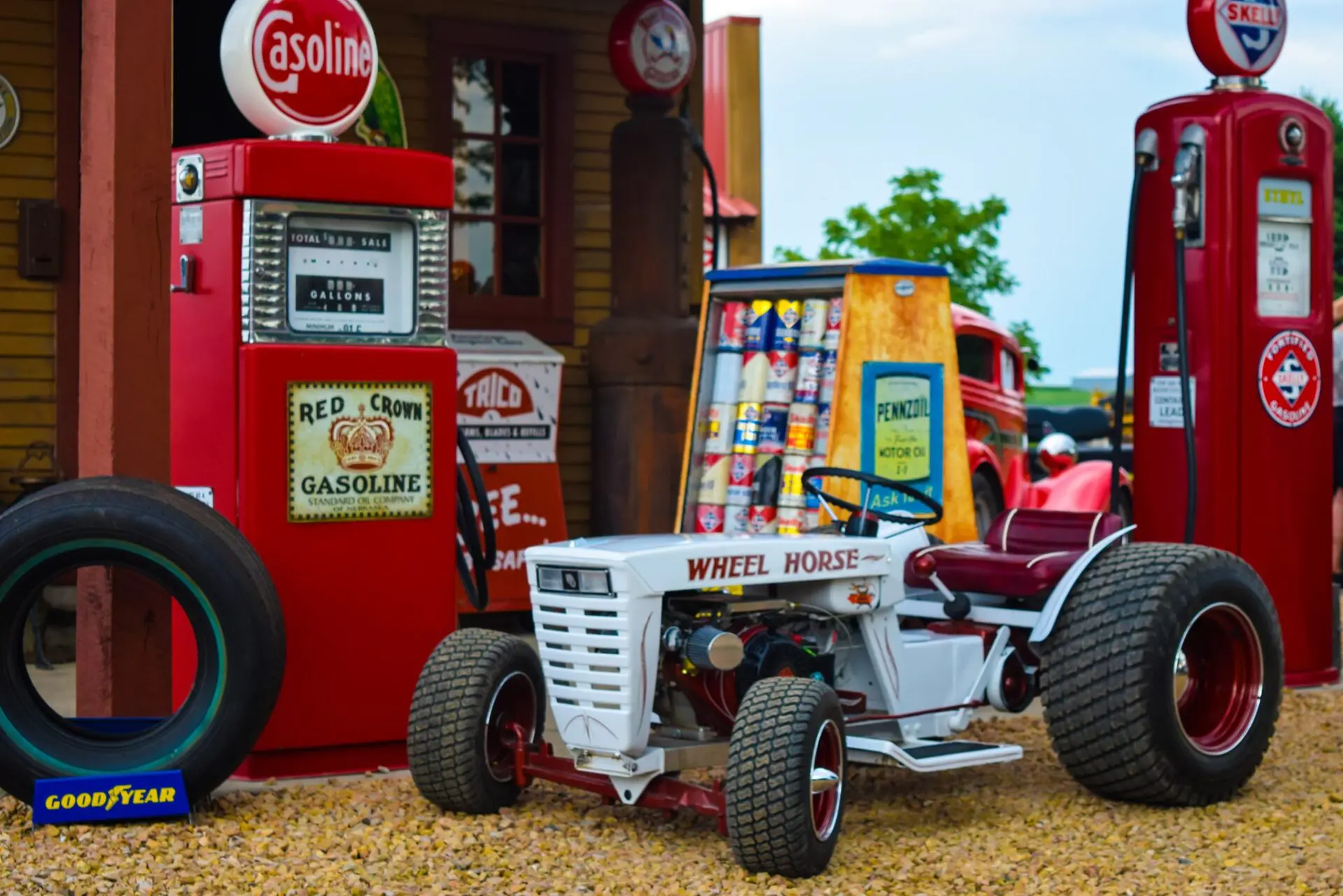 A tractor parked in front of a gas station.