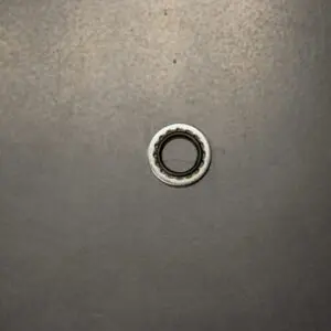 A small metal Backup Ring on a black surface.