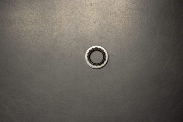 A small metal Backup Ring on a black surface.