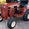 Red Wheel Horse tractor parked on concrete.